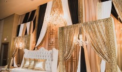 Indian wedding reception stage golden draping decorations. Indian wedding reception stage golden draping decorations.