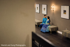 Indian couple sitting in a hall staring into each other's eyes Indian couple sitting in a hall staring into each other's eyes