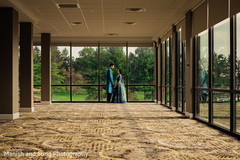 Indian couple holding hands in front of a window Indian couple holding hands in front of a window