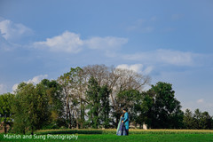 Indian couple embracing in the middle of the field Indian couple embracing in the middle of the field
