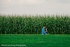 Indian couple sharing a moment in front of a corn field Indian couple sharing a moment in front of a corn field