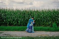 Indian couple dancing in front of a corn field Indian couple dancing in front of a corn field