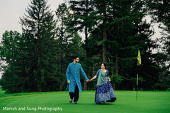 Indian couple walking the golf course hand in hand Indian couple walking the golf course hand in hand