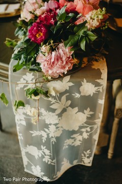 Ivory Indian wedding tablecloth and flowers centerpiece. Ivory Indian wedding tablecloth and flowers centerpiece.