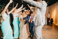 Joyful Indian couple walking between bridesmaids and groomsmen. Joyful Indian couple walking between bridesmaids and groomsmen.