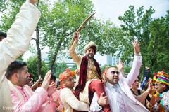 Indian groom lifted by groomsmen at baraat procession. Indian groom lifted by groomsmen at baraat procession.
