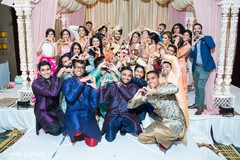 Indian couple posing with indian wedding guests. Indian couple posing with indian wedding guests.