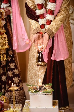 Indian groom throwing rice to sacred fire ritual. Indian groom throwing rice to sacred fire ritual.