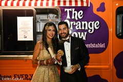 Indian couple tasting wedding reception cookies. Indian couple tasting wedding reception cookies.