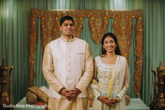 Indian couple standing in front of a stage Indian couple standing in front of a stage