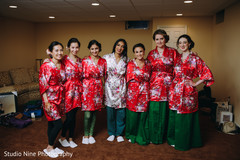 Indian bride and her Indian bridesmaids preparing for the ceremony Indian bride and her Indian bridesmaids preparing for the ceremony