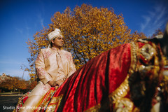 Indian groom riding a white mare Indian groom riding a white mare