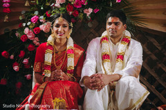 Indian couple sitting during the ceremony Indian couple sitting during the ceremony