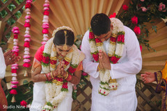 Indian couple saying a prayer Indian couple saying a prayer