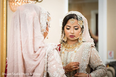 Indian bride looking at her attire in the mirror Indian bride looking at her attire in the mirror