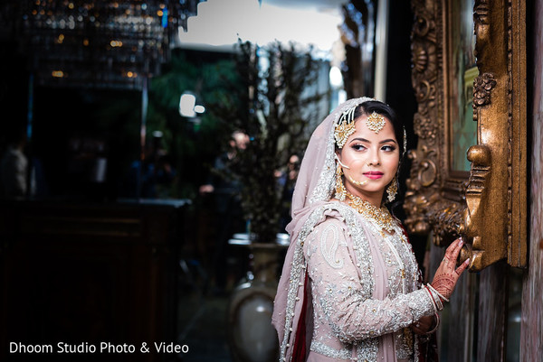 Indian bride posing by an unseen painting