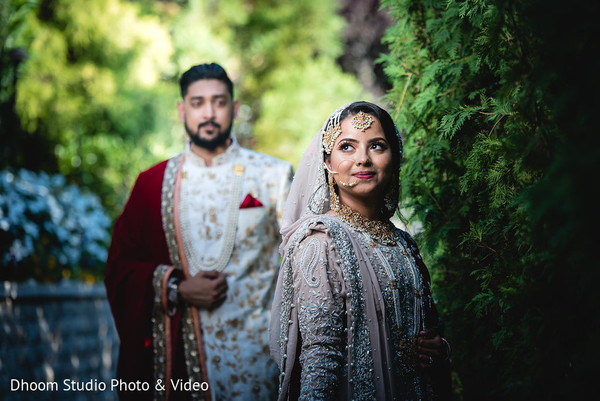 Maharani looking up while her Indian groom approaches