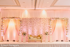 Indian wedding reception pink flowers and draping stage decor. Indian wedding reception pink flowers and draping stage decor.