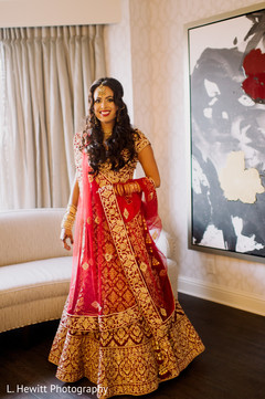 Indian bride wearing her golden and red wedding lehenga. Indian bride wearing her golden and red wedding lehenga.