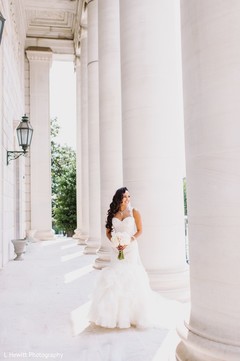 Indian bride posing on her white wedding dress. Indian bride posing on her white wedding dress.