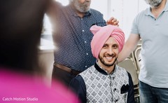 Indian groom getting his pink pagdi on. Indian groom getting his pink pagdi on.