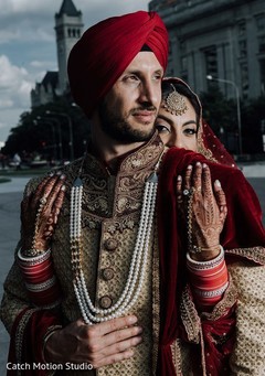 Indian groom and bride posing on their wedding ceremony red outfits. Indian groom and bride posing on their wedding ceremony red outfits.