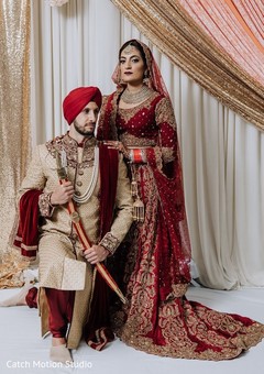 Indian bride and groom posing at ceremony mandap. Indian bride and groom posing at ceremony mandap.