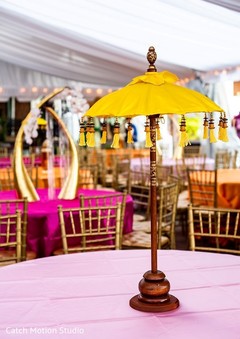Sangeet table centerpiece yellow and wood umbrella decoration. Sangeet table centerpiece yellow and wood umbrella decoration.