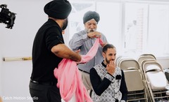 Indian groom getting his pink pre-wedding turban. Indian groom getting his pink pre-wedding turban.