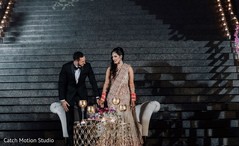 Indian couple taking a seat at wedding reception. Indian couple taking a seat at wedding reception.