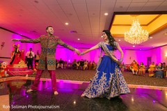Indian couple dancing during Sangeet Indian couple dancing during Sangeet