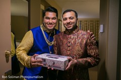Indian groom getting a present from best man. Indian groom getting a present from best man.