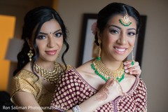 Indian bride getting her wedding ceremony kundan choker necklace. Indian bride getting her wedding ceremony kundan choker necklace.