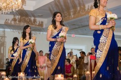 Indian bridesmaids on the aisle on their golden and royal blue sari. Indian bridesmaids on the aisle on their golden and royal blue sari.