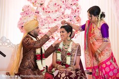 Indian bride getting the red mark on her forehead ritual. Indian bride getting the red mark on her forehead ritual.