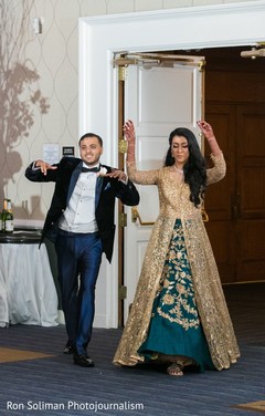 Indian couple making their entrance to wedding reception party. Indian couple making their entrance to wedding reception party.