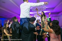 Indian couple being lifted at wedding reception celebration. Indian couple being lifted at wedding reception celebration.