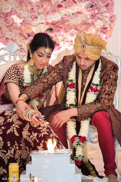 Indian couple pouring offerings to sacred fire. Indian couple pouring offerings to sacred fire.