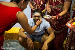 Indian groom getting cover with yellow paste. Indian groom getting cover with yellow paste.