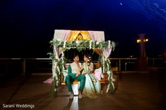 Indian couple posing at pre-wedding swing seat stage. Indian couple posing at pre-wedding swing seat stage.