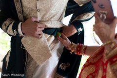 Maharani putting lemon on grooms pocket. Maharani putting lemon on grooms pocket.