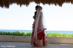Indian bride wearing her white and golden ghoonghat. Indian bride wearing her white and golden ghoonghat.