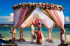 Indian couple posing at ceremony mandap. Indian couple posing at ceremony mandap.