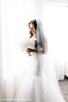 A full body shot of the Indian bride in her white wedding dress A full body shot of the Indian bride in her white wedding dress