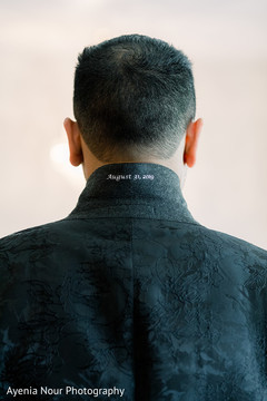 Indian groom showing the inscription on his suit jacket Indian groom showing the inscription on his suit jacket