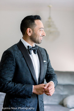 Indian groom in a black suit Indian groom in a black suit
