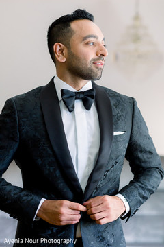 Indian groom in a black suit before the ceremony Indian groom in a black suit before the ceremony