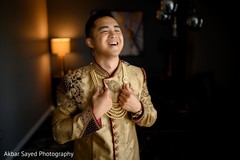 Indian groom putting on his Grooms mala necklace. Indian groom putting on his Grooms mala necklace.
