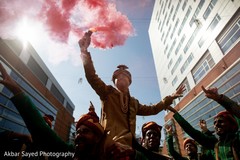 Indian groom holding a colored smoke stick. Indian groom holding a colored smoke stick.