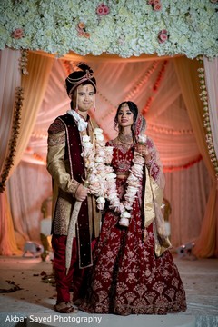 Indian couple posing on their wedding ceremony outfits. Indian couple posing on their wedding ceremony outfits.
